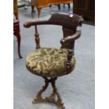 A MAHOGANY DESK OR CAPTAINS CHAIR WITH CIRCULAR SEAT UPHOLSTERED IN OLIVE GREY CUT VELVET AND