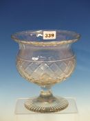 A FOOTED THISTLE SHAPED CLEAR GLASS BOWL, THE BODY WITH STRAWBERRY CUT DIAMOND DIAPER BAND ABOVE