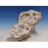 A PAIR OF QUARTZ GEODES, THE OCHRE EXTERIORS GNARLED AND CONTAINING SNOW WHITE AND CLEAR NESTS OF
