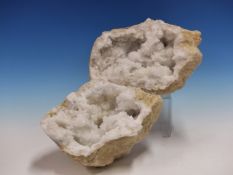 A PAIR OF QUARTZ GEODES, THE OCHRE EXTERIORS GNARLED AND CONTAINING SNOW WHITE AND CLEAR NESTS OF