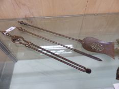 A SET OF THREE FIRE IRONS, TONGS, SHOVEL AND POKER, THE BALUSTER HANDLES WITH ACORN FINIALS.