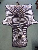 A BLUE CLOTH MOUNTED ZEBRA SKIN. W 280cms.