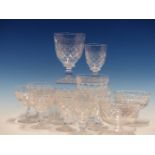 A TUDOR CLEAR GLASS DRINKING SET, EACH PIECE CUT WITH A BAND OF ROUNDELS ABOVE DIAMOND DIAPER AND
