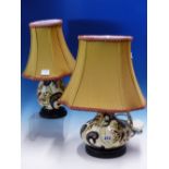 TWO MOORCROFT LAMP BASES SLIP TRAILED IN 1980'S STYLE WITH BUTTERFLIES AND BLACK BORDERED STYLISED