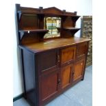 AN ARTS AND CRAFTS 1/4 SAWN OAK SIDE CABINET WITH RAISED SHELF BACK OVER ARRANGEMENT OF CABINET DOOR