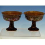 A PAIR OF CHINESE LAC BURGAUTE STEM CUPS, THE BLACK EXTERIORS INLAID WITH MOTHER OF PEARL FIGURES IN