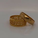 A 22ct GOLD FILIGREE RING SIZE Q TOGETHER WITH A 22ct GOLD WEDDING BAND FINGER SIZE P 1/2. GROSS