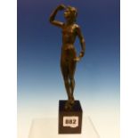 AFTER THE ANTIQUE, A BRONZE NUDE FEMALE HOLDING A LEAF IN ONE HAND AND SHIELDING HER EYES TO LOOK