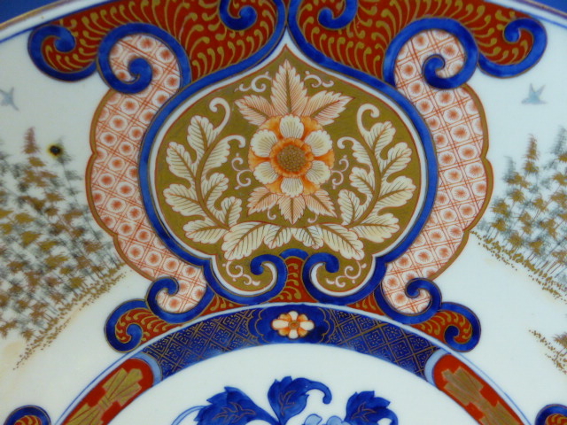 A FUKUGAWA IMARI DISH, THE RUYI FRAMED FLORAL LAPPETS ALTERNATING WITH STANDS OF BAMBOO AND - Image 10 of 18