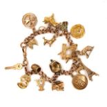 A 9ct GOLD VINTAGE CHARM BRACELET TO INCLUDE A MASONIC CHARM, POODLE, EIFEL TOWER, ENAMELLED ST