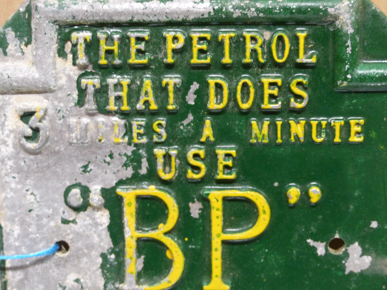 A GREEN AND YELLOW PAINTED HEXAGONAL ALUMINIUM BP ADVERTISING PLAQUE, THE PETROL THAT DOES 3 MILES A - Image 2 of 7