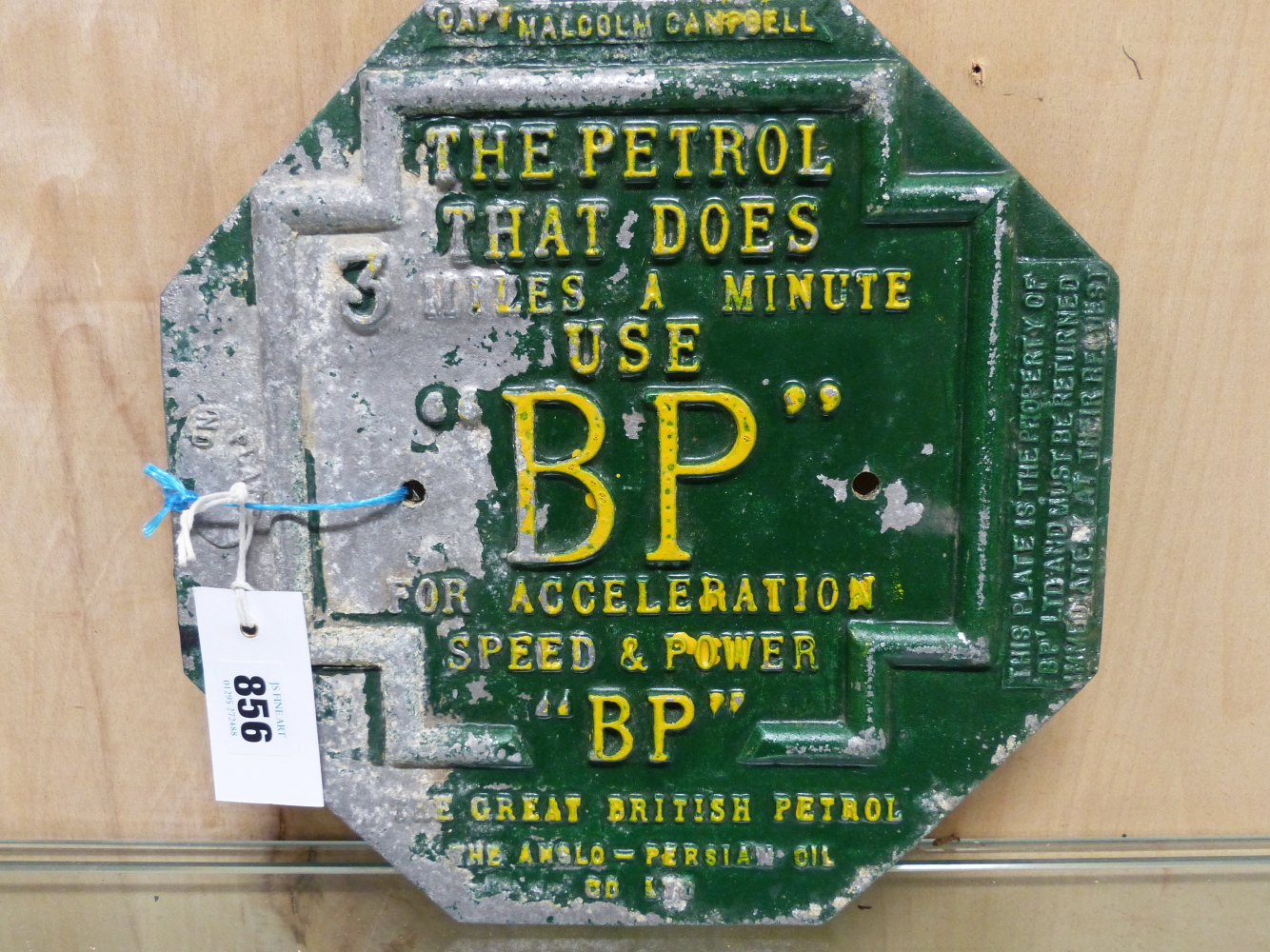 A GREEN AND YELLOW PAINTED HEXAGONAL ALUMINIUM BP ADVERTISING PLAQUE, THE PETROL THAT DOES 3 MILES A