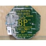 A GREEN AND YELLOW PAINTED HEXAGONAL ALUMINIUM BP ADVERTISING PLAQUE, THE PETROL THAT DOES 3 MILES A