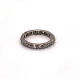 A WHITE METAL OLD CUT DIAMOND FULL ETERNITY RING WITH A SCROLL ENGRAVED SETTING. FINGER SIZE L 1/