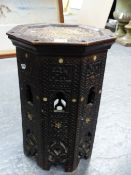 AN ISLAMIC OCTAGONAL TABLE, THE DISHED TOP AND SIDES INSCRIBED IN RELIEF, THE LATTER PIERCED WITH
