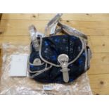 A RADLEY BLACK TEXTILE SHOULDER BAG PATTERNED WITH BLUE AND GREY BOWS, THE STRAP AND EDGINGS GREY/