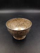 A WHITE METAL REPOUSSE ENGRAVED SMALL BOWL STAMPED ON REVERSE CARRINGTON & CO, LONDON, 130 REGENT