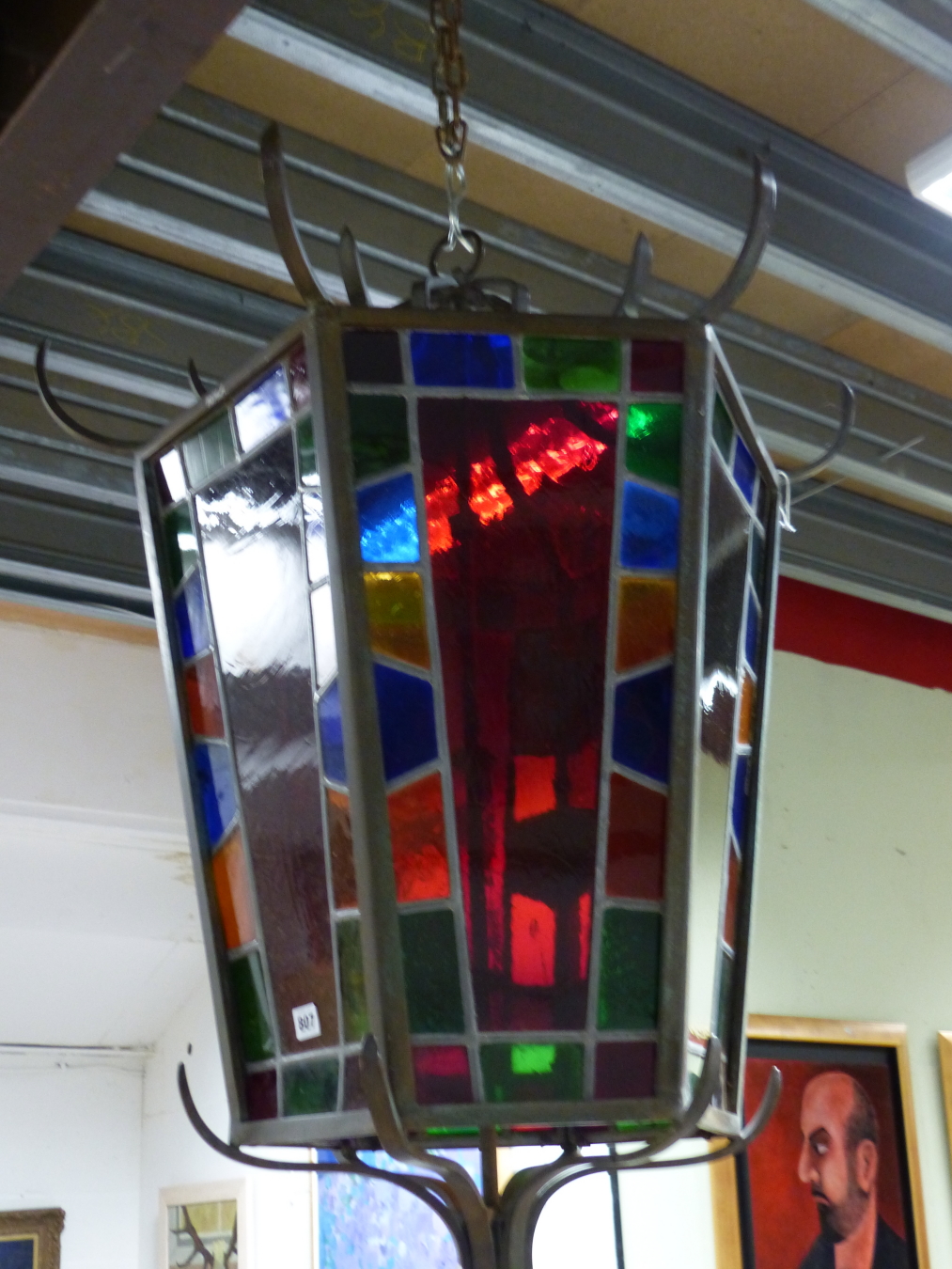 AN IMPRESSIVE BRONZE FRAMED HEXAGONAL HALL LANTERN WITH STAINED GLASS PANELS. MAX Dia.80cms x H.