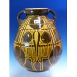 A WILLIAM AULT TWO HANDLED OVOID VASE WITH BROWN AND OCHRE SGRAFFITO SECESSIONIST DECORATION. H