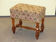 A BIRD'S EYE MAPLE BIDET STOOL, THE FLUTED AND CABOCHON BANDED LEGS JOINED BY H STRETCHER, THE