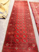 AN AFGHAN BOKHARA RUNNER 284 x 230cms.