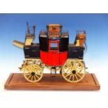 A MICHAT BOGAJEWICZ SCALE MODEL MAIL COACH WITH RED BODY AND YELLOW WHEELS, A WICKER BASKET
