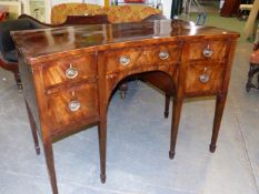 AN ANTIQUE GEORGIAN STYLE MAHOGANY SIDE BOARD, THE CROSS BANDED TOP WITH CONCAVE FRONT, THE