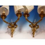 A PAIR OF ORMOLU TWO BRANCH WALL LIGHTS, THE CLASSICALLY DRAPED NOZZLES AND FLUTED ARMS ON RIBBON