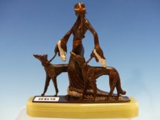 A COLD PAINTED BRONZE GROUP OF AN ART DECO LADY WALKING TWO SELUKIS OVER A SHAPED GREEN ONYX PLINTH.