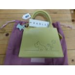 A RADLEY YELLOW LEATHER HANDBAG STIPPLE PIERCED ON ONE SIDE WITH A SCOTTIE DOG SEATED BY A FLOWER
