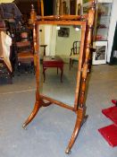 AN EBONY EDGED MAHOGANY RECTANGULAR CHEVAL DRESSING MIRROR, THE BALUSTER TURNED SUPPORTS ON EBONY