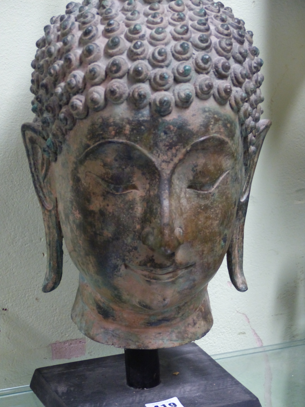 A THAI BRONZE HEAD OF THE BUDDHA, CURLED HAIR ABOVE HIS LONG LOBED EARS, HIS USNISA WITH FLAME - Image 3 of 10