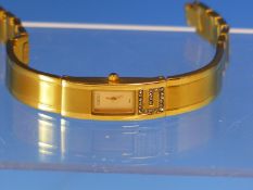 A LADIES GOLD PLATED BRACELET STRAP GUCCI WATCH. MODEL NUMBER 255L TOGETHER WITH A DOUBLE DIAMOND