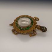 A YELLOW METAL GEMSET TORTOISE BROOCH. THE SHELL SET WITH A BAROQUE PEARL SURROUNDED BY A HALO OF