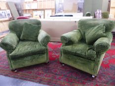 A PAIR OF GOOD QUALITY DEEP SEAT CLUB ARMCHAIRS UPHOLSTERED IN QUALITY GREEN VELVET ON BUN FEET WITH