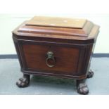 A REGENCY MAHOGANY SARCOPHAGUS SHAPED WINE COOLER, THE HINGED LID OPENING ONTO A METAL LINER, THE