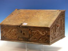 A 17th C. OAK BIBLE BOX WITH SLOPING HINGED LID AND RELIEF CARVED SIDES, THE INTERIOR ONCE WITH