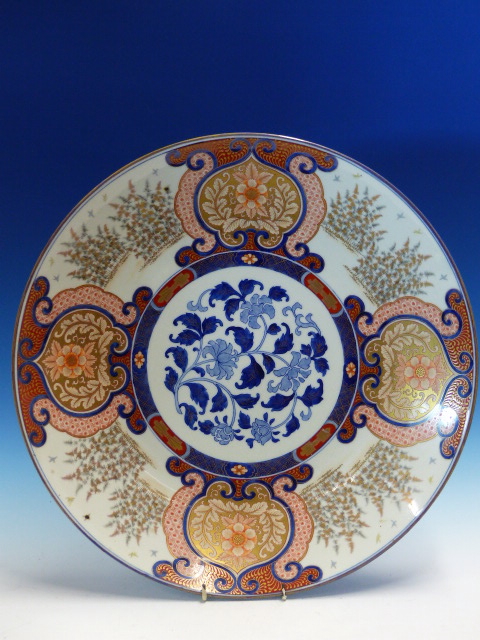 A FUKUGAWA IMARI DISH, THE RUYI FRAMED FLORAL LAPPETS ALTERNATING WITH STANDS OF BAMBOO AND