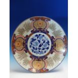 A FUKUGAWA IMARI DISH, THE RUYI FRAMED FLORAL LAPPETS ALTERNATING WITH STANDS OF BAMBOO AND