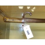 A SWORD BAYONET, POSSIBLY 19th C. FRENCH, THE BRASS HANDLE WITH CHAMFERED SLOT, THE GUARD WITH