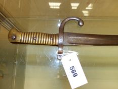 A SWORD BAYONET, POSSIBLY 19th C. FRENCH, THE BRASS HANDLE WITH CHAMFERED SLOT, THE GUARD WITH