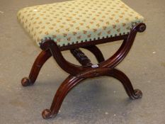 A MAHOGANY STOOL, THE NEEDLE WORK SEAT ABOVE CURVED X-SHAPED LEGS CENTRALLY JOINED BY A BALUSTER