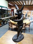 A BRONZE FIGURE OF A COWBOY RABBIT WALKING ON HIND LEGS AND AIMING HIS DOUBLE BARREL SHOTGUN FROM