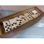 A BOXED SET OF BONE AND EBONY DOMINOES TOGETHER WITH AN AUTOBRIDGE GAME SET.