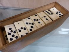 A BOXED SET OF BONE AND EBONY DOMINOES TOGETHER WITH AN AUTOBRIDGE GAME SET.