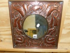 A SQUARE FRAMED COPPER CIRCULAR MIRROR, THE FRAME WORKED WITH A BIRD AMONGST FOLIAGE ON A MARTELE