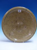 A CELADON DISH, THE SHALLOW CURVED CENTRE WITH SIX SPUR MARKS. Dia. 35.5cms