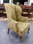 A GEORGIAN AND LATER WING BACK ARMCHAIR ON CARVED CABRIOLE FORELEGS.