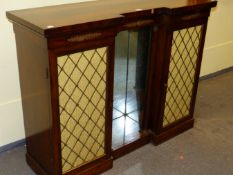 A REGENCY STYLE ROSEWOOD INVERTED BREAKFRONT SMALL SIDE CABINET WITH RECESSED MIRROR FLANKED BY
