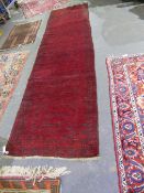 AN AFGAN BOKHARA RUNNER 387 x 101cms.